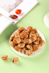 Traditional Guangxi Sesame Seed Balls - Crispy Chinese Pastries Snacks on Green Background