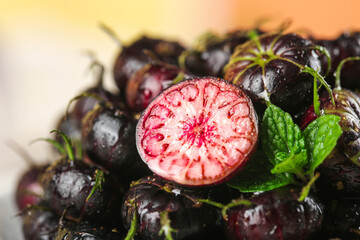 Fresh Wild Radishes with Red Marbled Interior and Green Leaves on Golden Background