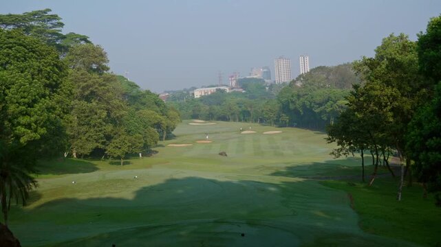 Jakarta, Indonesia-Nov 14, 2025: establish view of golf course with background of urban buildings