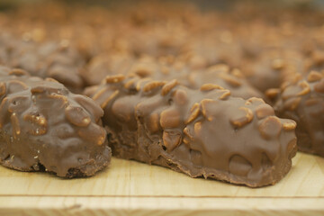 Delicious chocolate-covered snacks on a wooden tray