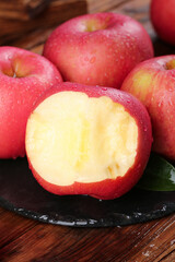 Fresh Red Fuji Apples with Cut Half Showing White Flesh on Slate Display Board