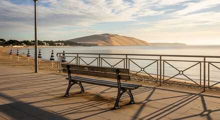 Serene coastal bench overlooking calm ocean and hill.