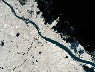 Urban planning analysis from space showing river, city layout, and building footprint with detailed urban infrastructure