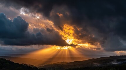 Dramatic Sunset Over Mountains with Golden Sunlight Beams