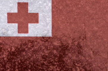 National flag of Tonga on a background of snow with large snow crystals close-up
