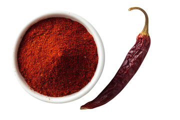 Red chili powder in small bowl, next to dried chili pepper