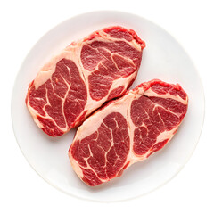 Two Raw Ribeye Steaks on a White Plate with Black Background raw meat uncooked