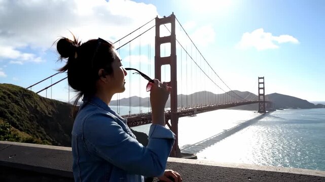 Tourist admiring Golden Gate Bridge viewing platform cinematic handheld iconic tourism lifestyle stock video. sightseer marveling suspension bridge vista point filmic portable