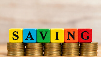 Colourful cubes in bright matte shades spelling SAVING on coin stacks