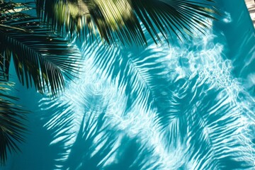 Lush tropical leaves casting shadows over a refreshing pool.