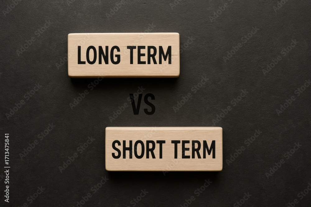 Poster long term investment. comparison of long-term and short-term concepts using wooden blocks on a dark 