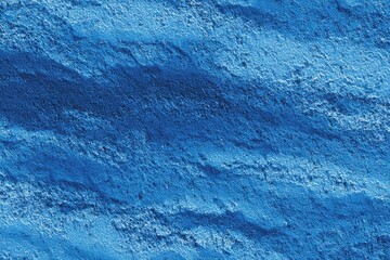 Close-up texture of a deep blue, coarse material with visible grooves and an uneven surface