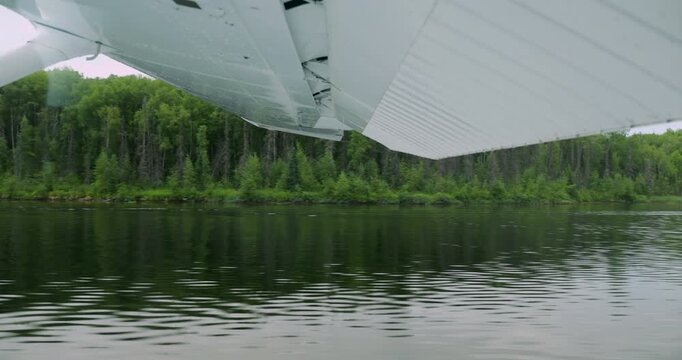 Floatplane taking off from the lake in Alaska.
View from the inside of the aircraft.