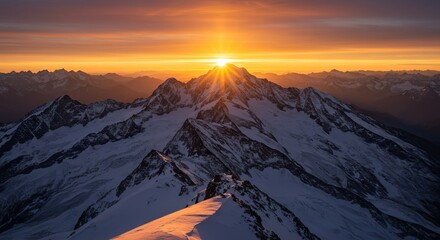 Snowy peaks meet a fiery sky Sunburst piercing mountain crown