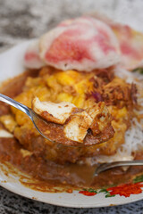 Ketoprak, captured on September 19, 2025. Traditional Indonesian dish of rice cake, vermicelli, tofu, bean sprouts, and peanut sauce, topped with crispy omelet and served with crackers