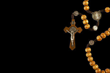 wooden rosary on left with space for text on right on black background