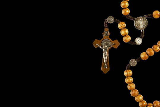 wooden rosary on left with space for text on right on black background