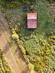 Drone aerial view of an old barn and autumn colors. Scenic countryside landscape foliage, trees, and natural habitat. Vertical View optimized for mobile devices