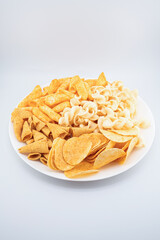 Assorted Crispy Snacks Mix in White Bowl on White Background