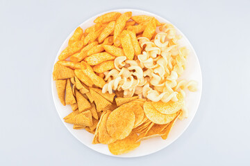 Assorted Crispy Snacks Mix in White Bowl on White Background