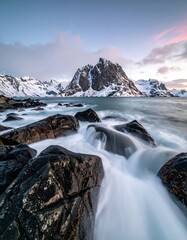 Snowy mountain fjord at dawn