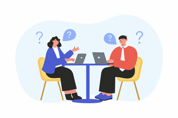 Two people sitting at a table with laptops and question marks above their heads symbolizing confusion or a problem solving session