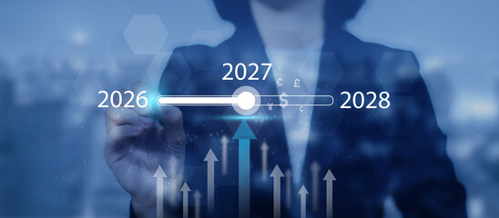 A businesswoman touches a digital progress bar indicating the transition from 2026 to 2027 2028,...