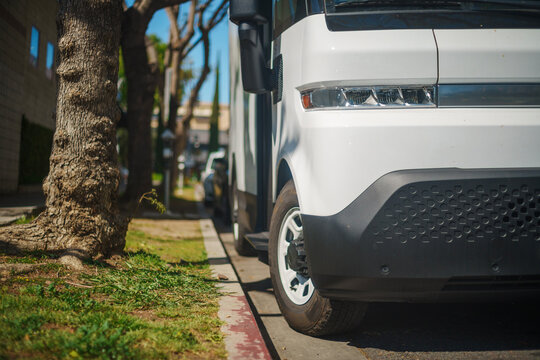 White electric truck in the city. Closeup on headlight. - Powered by Adobe