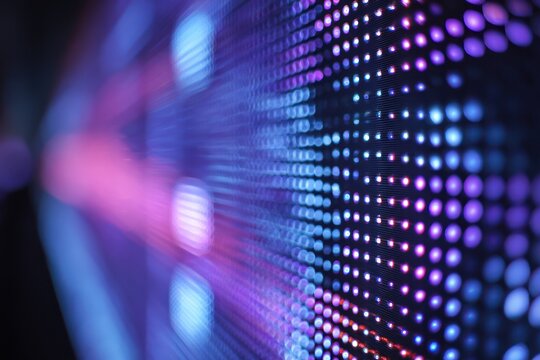 Abstract view of illuminated purple & blue LED screen. Dots create depth as they fade away to left