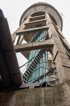 Exploring the unique architecture of a water tower on a cloudy d