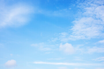 Blue sky background and white clouds soft focus, and copy space horizontal shape.