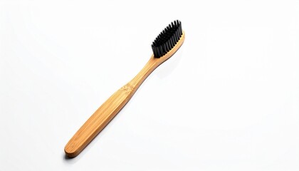 Eco friendly bamboo toothbrush with black charcoal bristles isolated on a white background for sustainable dental care.