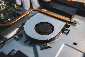 Close-up image of an all-in-one computer interior showing the motherboard, heat pipe cooling system, RAM slot, processor, and electronic components. Inside View of All-in-One Computer Motherboard