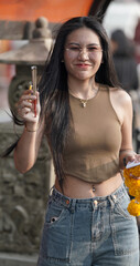 Thai Girl at Temple & river to make merit 