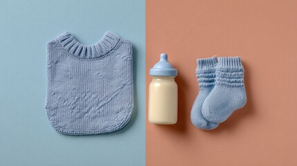 Overhead shot of baby bib, bottle and socks on twotone background, essential items for a newborn baby, flat lay