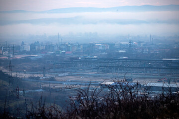 Factory in winter fog, dirty pollution city