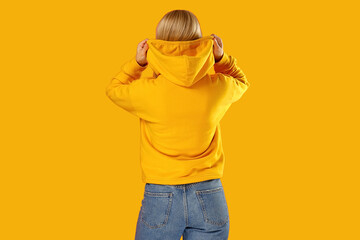Model showcases casual hoodie design in vibrant yellow color