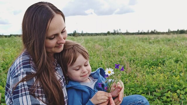 Happy family. mom and son in nature. Mom, child play together in park. Family walk in outdoors. Parents, daughter having carefree fun in nature, they enjoy nature.