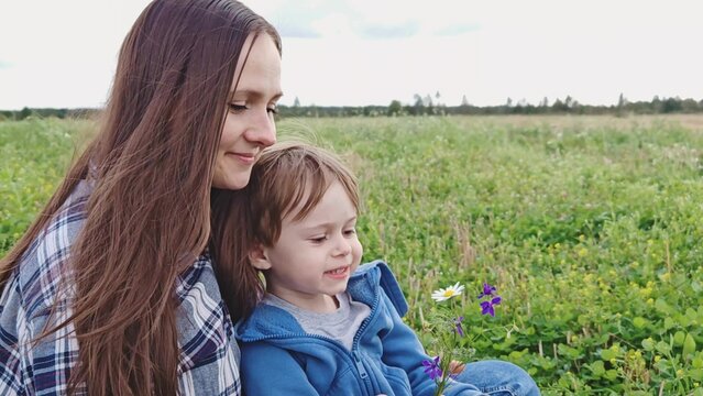 Happy family. mom and son in nature. Mom, child play together in park. Family walk in outdoors. Parents, daughter having carefree fun in nature, they enjoy nature.