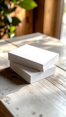 Stack of blank white papers on a wooden table