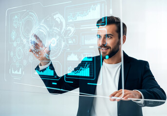 Man interacting with a futuristic holographic interface displaying financial charts and data, representing technology and innovation in business