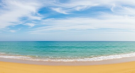 Obraz premium Tranquil ocean vista with soft, pale sand beach and a clear blue sky, featuring gentle waves lapping against the shore.