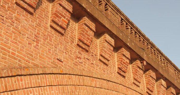 Closeup view of brick architecture Albi railway bridge during noon in France. Red bricks.