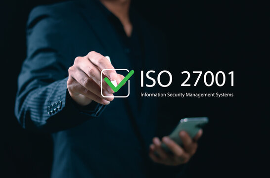 ISO 27001 concept. requirements, certification, management, standards. Businessman using tablet to choose ISO 27001 for information security management system (ISMS).