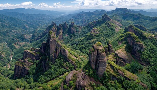 Aerial view of rugged mountains, forests, and valleys
