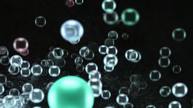Colorful bubbles floating on a black background animation