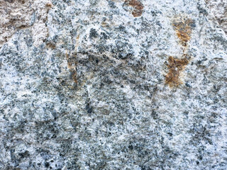 Close-up of weathered granite rock surface texture with natural patterns