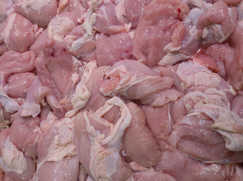 Raw Chicken Pieces: A close-up shot highlights a pile of fresh, uncooked chicken pieces, showcasing the texture and color of poultry meat for culinary, food preparation or protein source images.