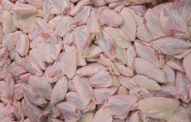 Raw Chicken Wings: A top-down perspective reveals a large, appetizing pile of raw chicken wings, ready for cooking and culinary exploration. capturing freshness and readiness.
