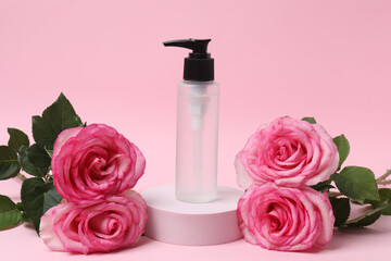 pink roses, cosmetic jars on a pink background
